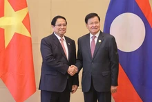 Prime Minister Pham Minh Chinh (L) meets with General Secretary of the Lao People’s Revolutionary Party (LPRP) and President of Laos Thongloun Sisoulith in Tianjin, China on September 1 (Photo: VNA)