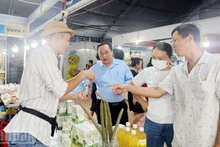 Visitors explore display booths at the An Giang Tourism and Cuisine Festival, combined with the Rach Gia Trade Promotion Fair and OCOP Product Exhibition 2025. (Photo: nhandan.vn)