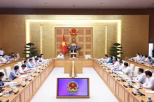 Prime Minister Pham Minh Chinh addresses a conference reviewing one month of running the two-tier local administration system on July 28. (Photo: VNA)