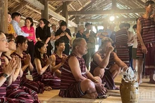 Visitors attend an event featuring the re-enactment of a Cho Ro worship ceremony (Dong Nai) at the Viet Nam National Village for Ethnic Culture and Tourism.