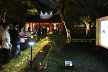 Visitors take part in the “Temple of Literature – Quoc Tu Giam” night experience tour. (Photo: THANH NGUYEN)