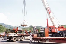 Workers of Huu Nghi Xuan Cuong Joint Stock Company operate specialised cranes for cargo transshipment at Huu Nghi Border Gate in Lang Son Province.