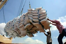 Workers load rice bags onto a vessel for delivery. (Photo: VNA)