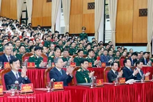 Party General Secretary To Lam (front, second, left) attends a meeting with the Military Technical Academy on March 17. (Photo: VNA)
