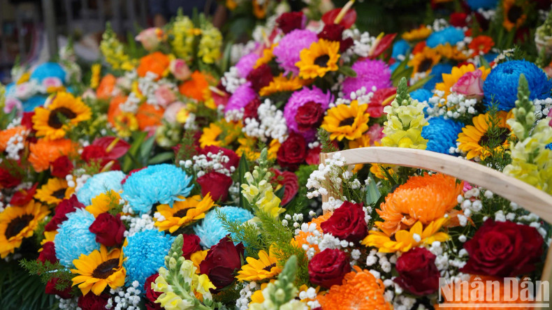 Many colorful flowers are sold at the market.
