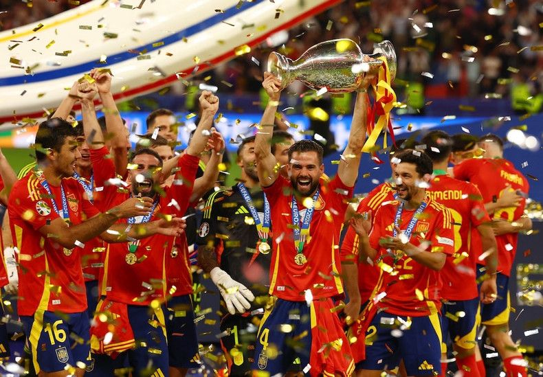Nacho lifts the trophy high in celebration of the victory. Nacho lifts the trophy high in celebration of the victory.