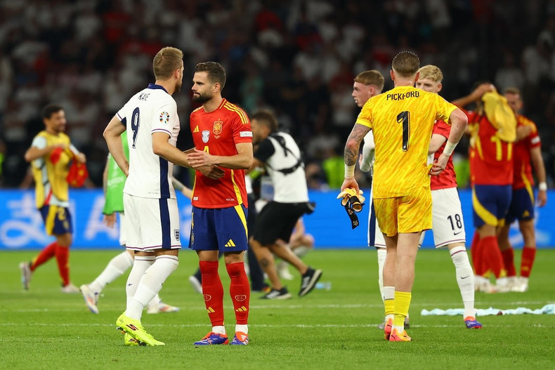 Harry Kane is consoled by Nacho after the match. Harry Kane is consoled by Nacho after the match.