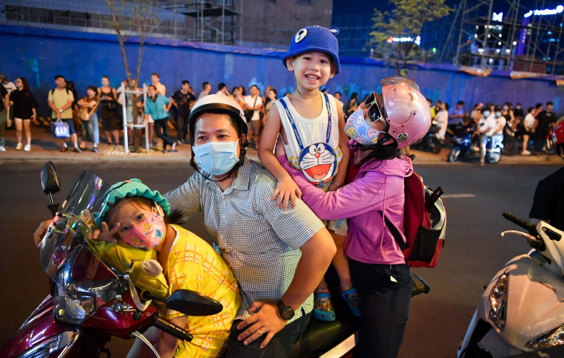 Many people stop right on the side of the street to enjoy the rock show.