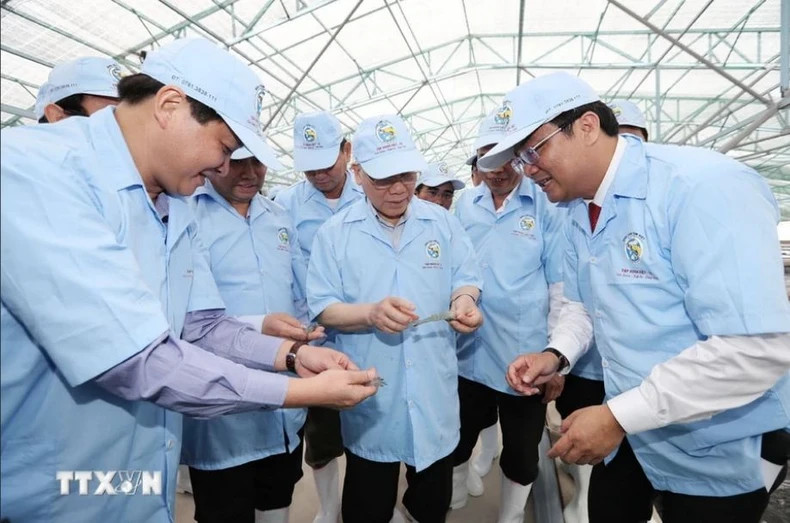 Party chief Nguyen Phu Trong visits the super-intensive shrimp farming model in an enclosed house of Viet Uc-Bac Lieu Joint Stock Company in Vinh Thinh Commune, Hoa Binh District in February 2017.