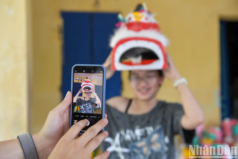 Young people are excited about the traditional papier-mâché masks. Young people are excited about the traditional papier-mâché masks.