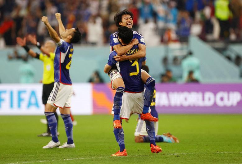 Japan players celebrate qualifying for the knockout stages. (Photo: REUTERS)