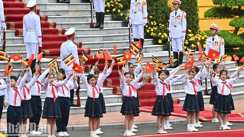 Vietnamese children welcome Ugandan President Yoweri Kaguta Museveni.