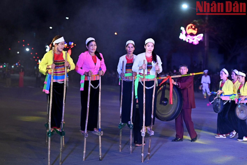 Muong ethnic minority people from Nho Quan district, Ninh Binh province, walk on stilts at the festival