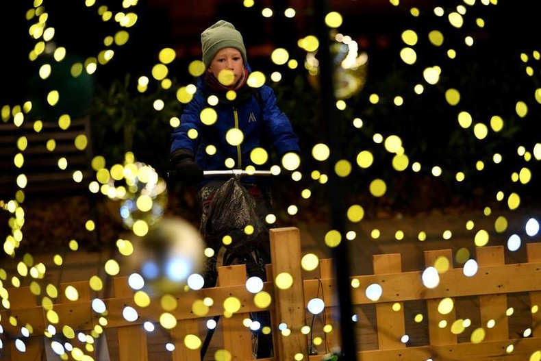 A boy rides a bicycle to power a Christmas lights installation in a district square in Budapest, Hungary, to save costs with sustainable lights. (Photo: Reuters)