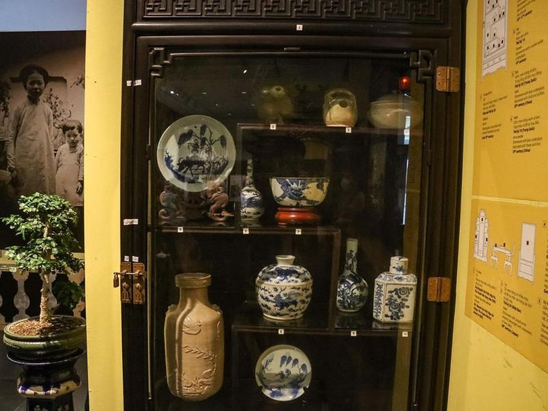 A cabinet containing many ancient artefacts of Hanoians in the early 20th century, such as lime vases, bowls and plates.