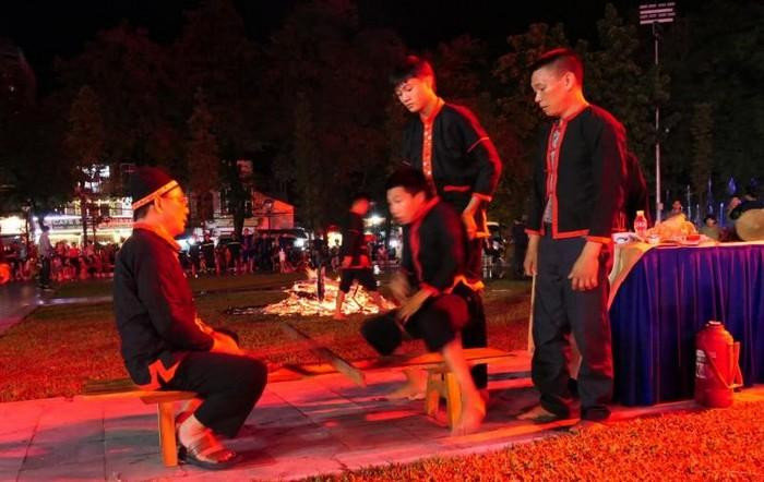 After nearly one hour of performing the ritual, Pa Then men sit opposite the shaman to prepare for the dance. After nearly one hour of performing the ritual, Pa Then men sit opposite the shaman to prepare for the dance.