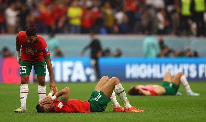Morocco's Yahya Attiat-Allah comforts Jawad El Yamiq after the match as Morocco are eliminated from the World Cup. (Photo: REUTERS)