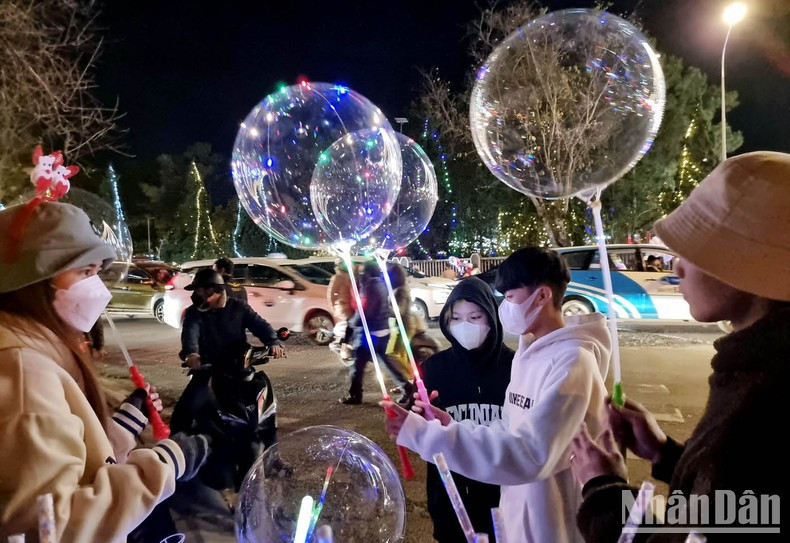 Balloons attached with lights attract customers on Christmas Eve.