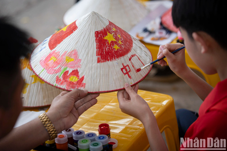 A student from the Chinese delegation is seen completing her artwork. A student from the Chinese delegation is seen completing her artwork.