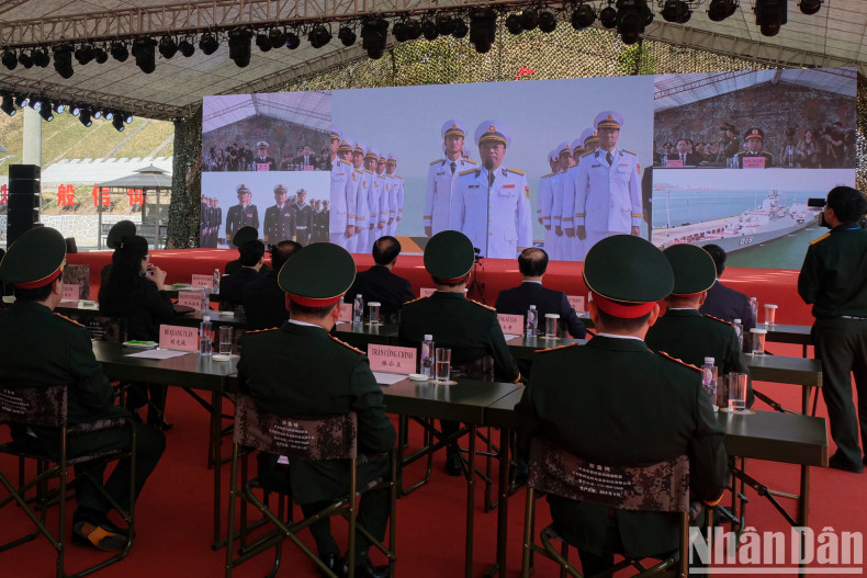 Delegates observe a live report from the naval joint patrol teams of both countries prior to their coordinated patrol.