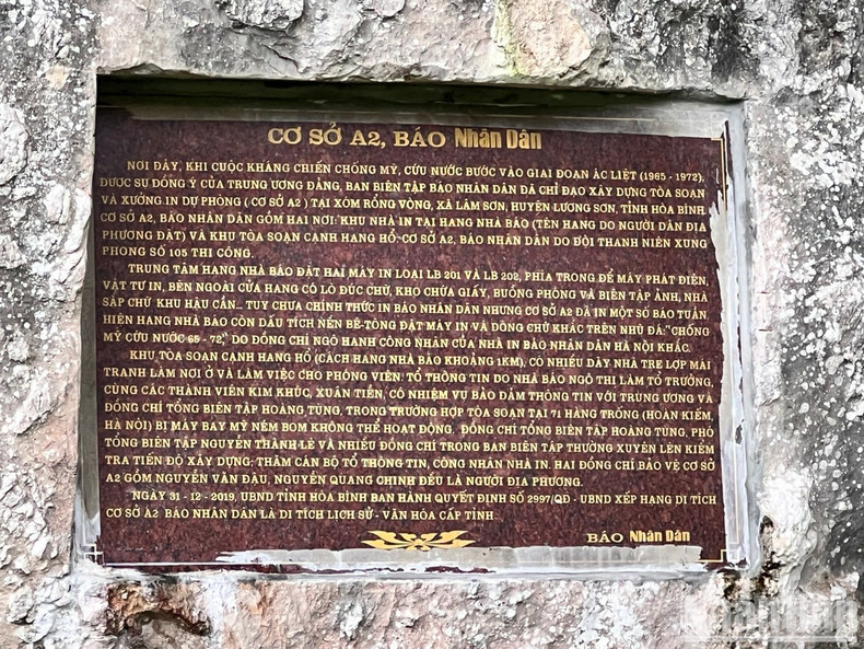 A plaque reading “Base A2, Nhan Dan Newspaper” outside the entrance of the Journalist Cave