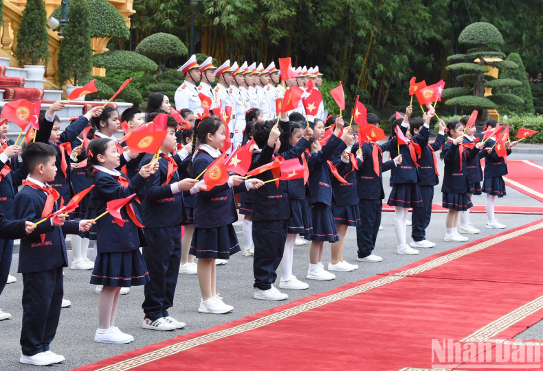 The children wave to the two Prime Ministers.