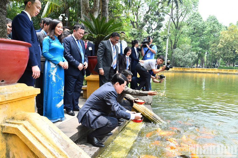 Both leaders feed the fish in President Ho Chi Minh’s fish pond.
