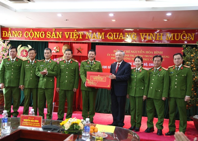 Permanent Deputy Prime Minister Nguyen Hoa Binh presents Tet gifts to officers and soldiers of the Environmental Police Force. (Photo: DINH HAI)