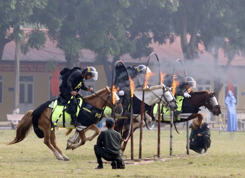 The Cavalry Mobile Police soldiers jump through rings of fire. (Photo: VNA)
