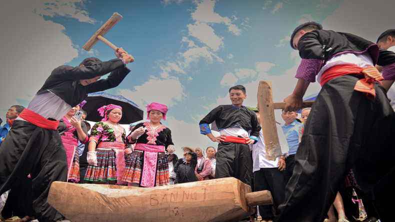 People take turns pounding the sticky rice continuously while it's still hot, to ensure smoothness and elasticity.