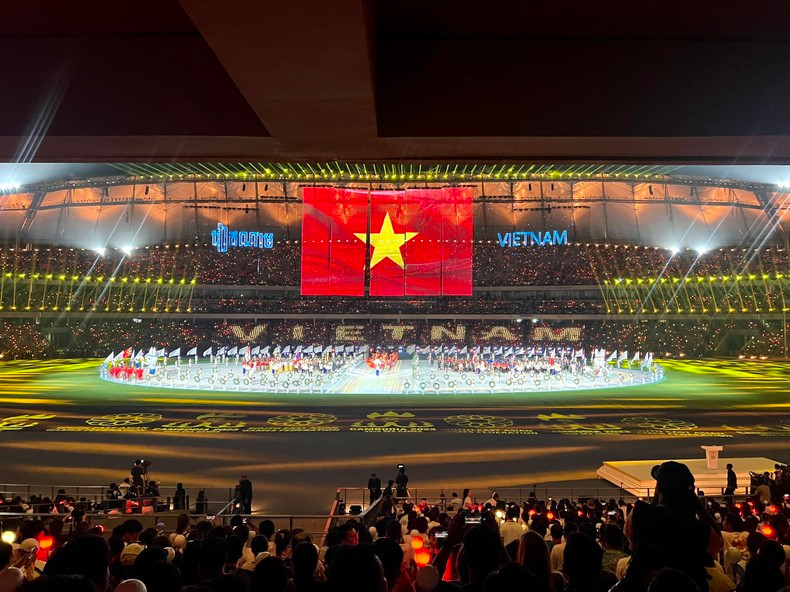 The organising committee uses a modern projection screen to show the national flags of the countries.