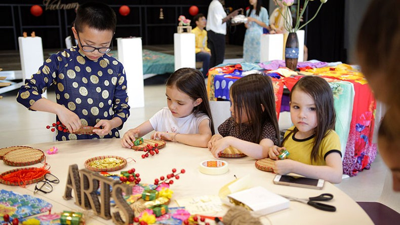 Children learning how to decorate bamboo mats.
