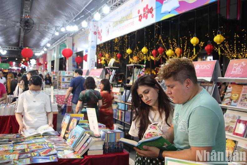 Foreign tourists visit the Tet book street on New Year's Eve. (Photo: Linh Bao-The Anh)