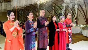 Members of the Viet Nam Ao Dai Club offer incense in tribute to the Patron Ancestor of the tailoring profession.