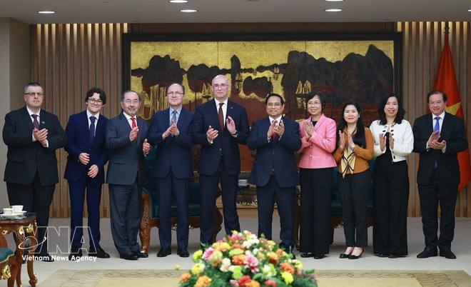 Prime Minister Pham Minh Chinh and TASS Director General Andrey Kondrashov pose for a photo with other delegates (Photo: VNA(