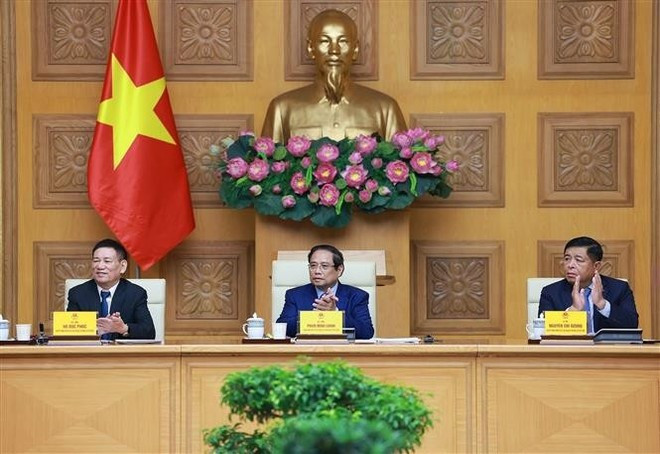 Prime Minister Pham Minh Chinh (centre) at the meeting (Photo: VNA) Prime Minister Pham Minh Chinh (centre) at the meeting (Photo: VNA)