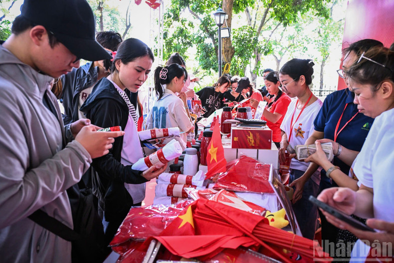 After collecting paper tickets, people could visit the souvenir stalls offering concert merchandise, such as the T-shirts and national flags. image-5.jpg