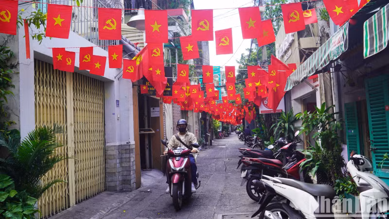 An alley in District 1 is sparkling with the colors of the red flag with yellow star. An alley in District 1 is sparkling with the colors of the red flag with yellow star.