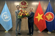 Lao Ambassador to the UN Thongphane Savanphet (right) congratulates Vietnamese Ambassador Do Hung Viet and the Vietnamese Mission on Viet Nam's National Day. (Photo: VNA)
