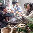 Visitors experience traditional coffee roasting of the E De people.