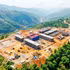 Multi-level boarding schools rise amid the rugged mountain landscape. 