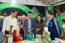 Delegates view products on display at the fair.