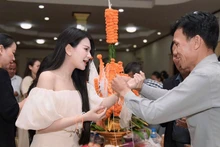 An Thu An at a traditional Lao wrist-tying ceremony. (Photo: Courtesy of the artist)