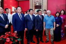 Delegates visit the historic house at 48 Hang Ngang Street.