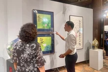 Visitors explore the 'Lotus and Kieu cultural space' exhibition