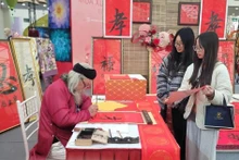 Young people seek calligraphy for good fortune during a fair in Ha Noi. (Photo: VNA)