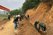 Soldiers and residents join forces to clear sediment from irrigation channels, ensuring water flow for agriculture after floods and landslides.