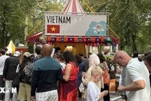 Visitors line up to enjoy "Pho (Vietnamese noodle soup) at the festival. (Photo: VNA)