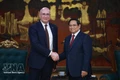 Prime Minister Pham Minh Chinh (R) welcomes TASS Director General Andrey Kondrashov (Photo: VNA) 