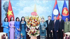 A delegation of the Viet Nam Women’s Union extends congratulations to the Lao Embassy in Viet Nam on the 50th anniversary of National Day of Laos. (Photo: hoilhpn.org.vn)